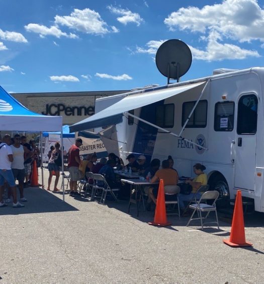 A disaster response trailer and tent outside an AT&T retail store