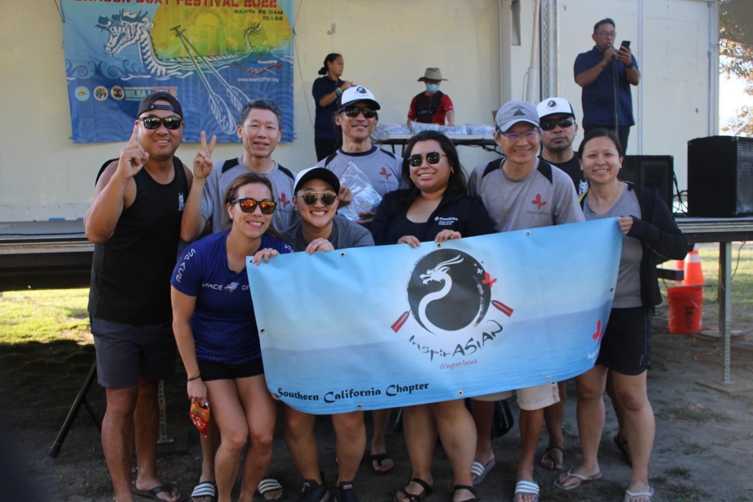 Team members pose with race banner