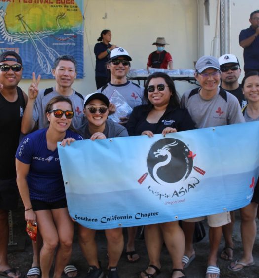 Team members pose with race banner