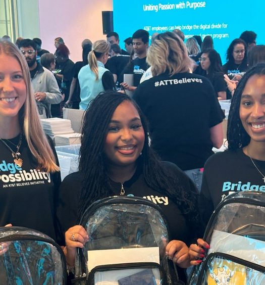 Amber and coworkers hold backpacks