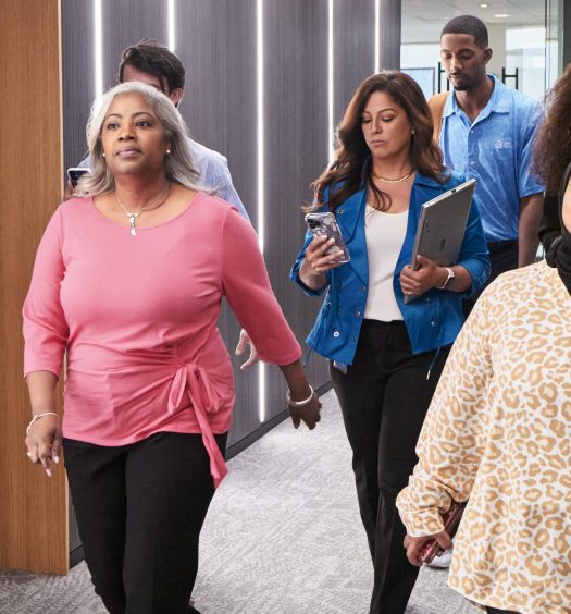 Team members walk through hallway