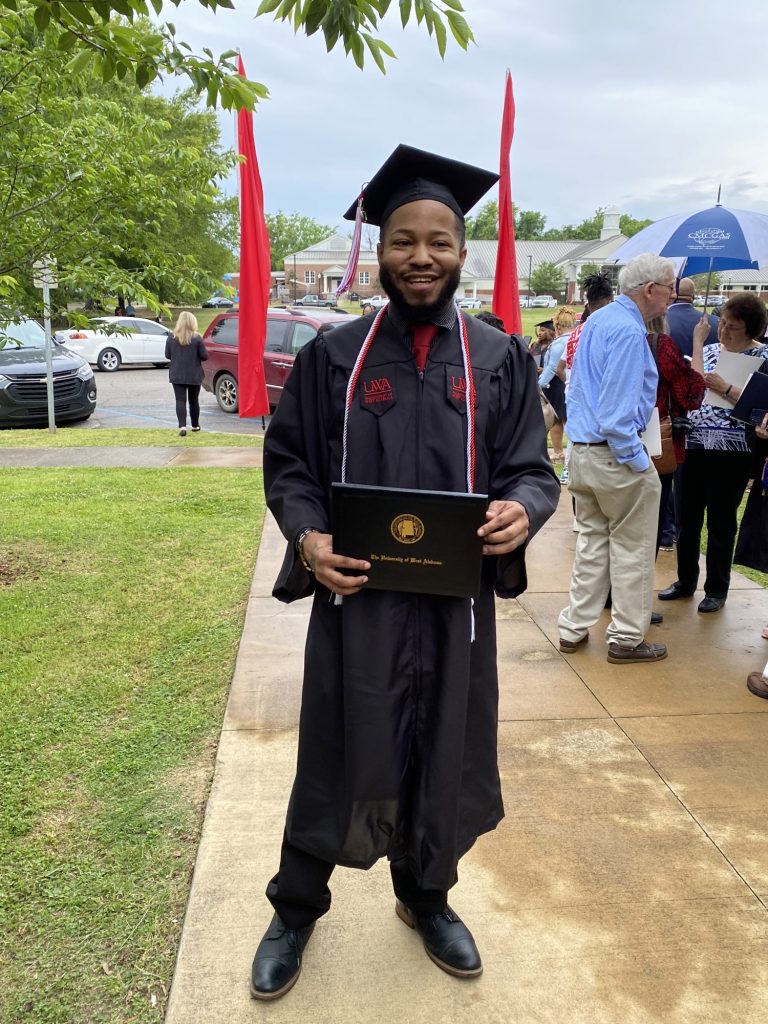 Phillip in graduation robes