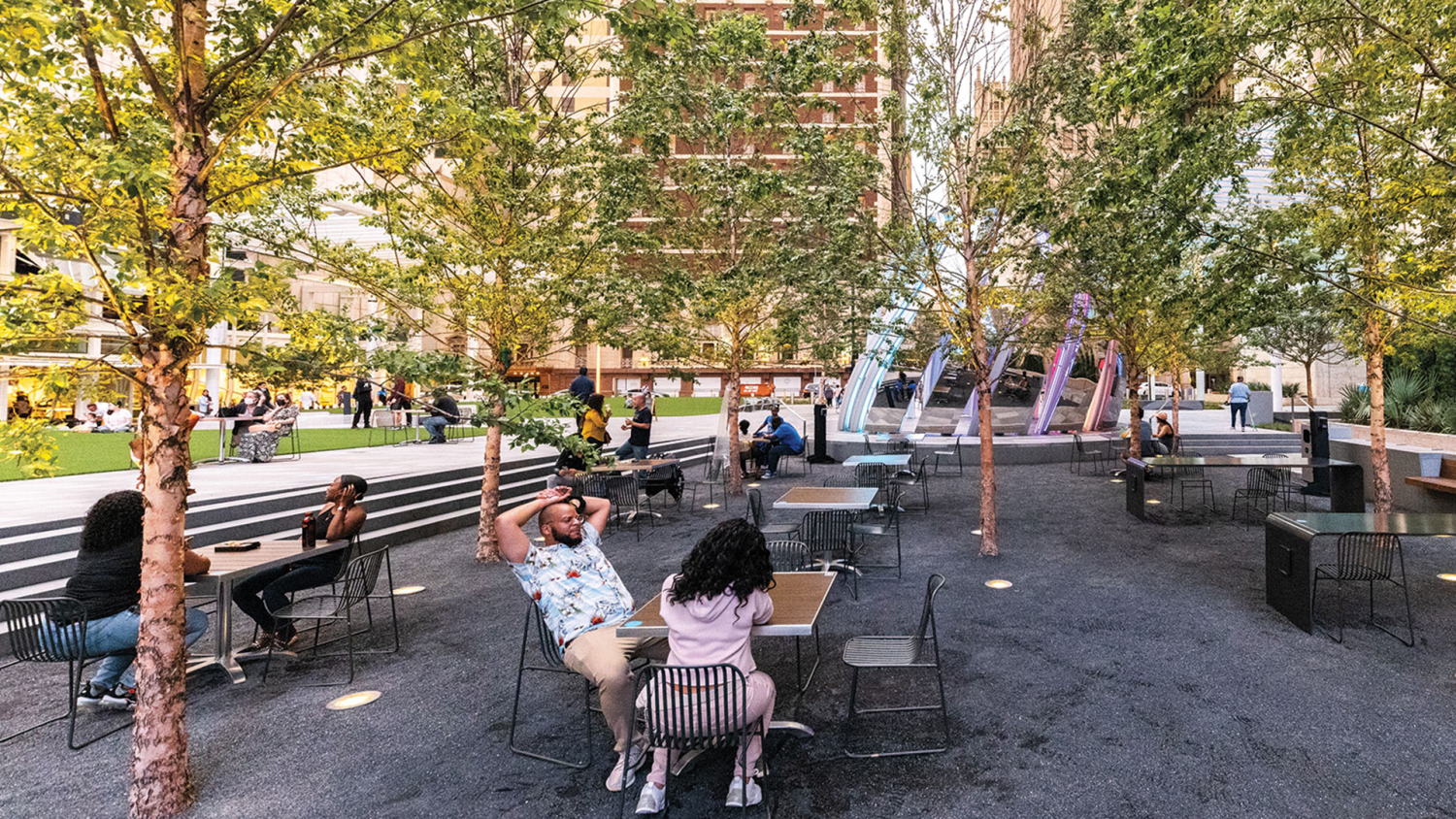 people talking at an outdoor table