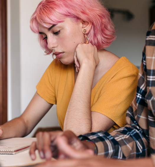 A man and a woman working on laptops