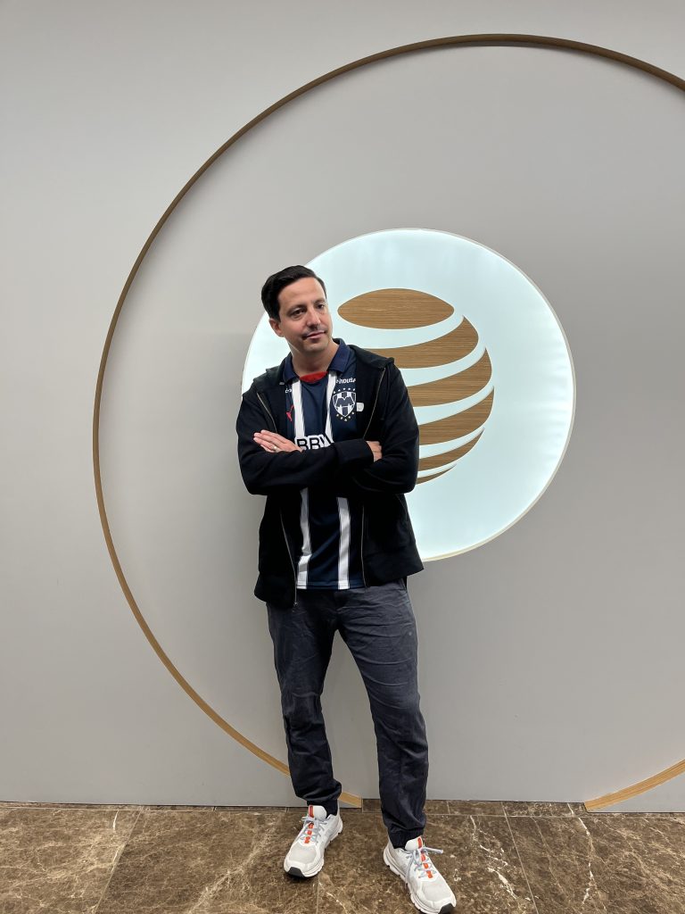 Man in dark jeans with a soccer jersey and hoodie on top