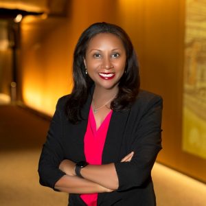 women in business attire crosses her arms