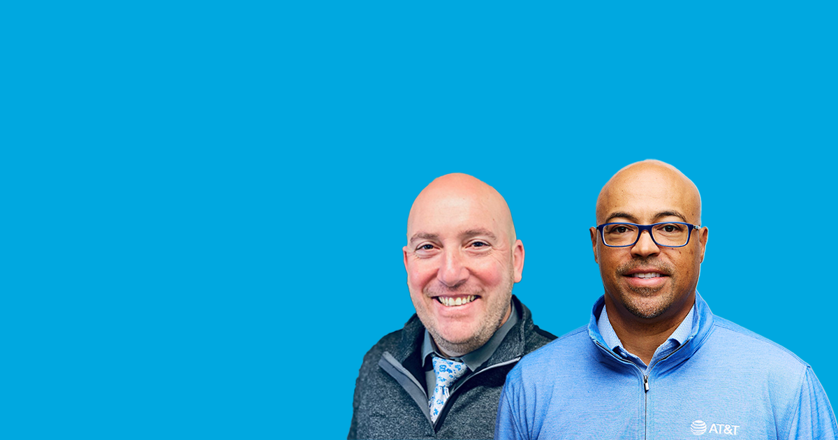 Two men in business attire in front of blue background