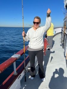 Amy holds up a fish