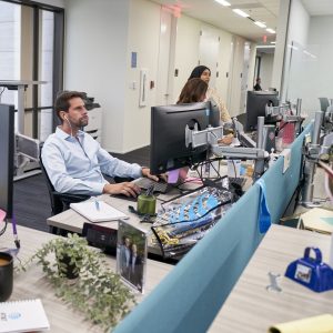 Employees work at desks in AT&T HQ
