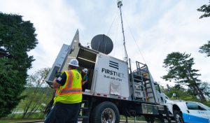 Technician takes equipment out of a FirstNet truck