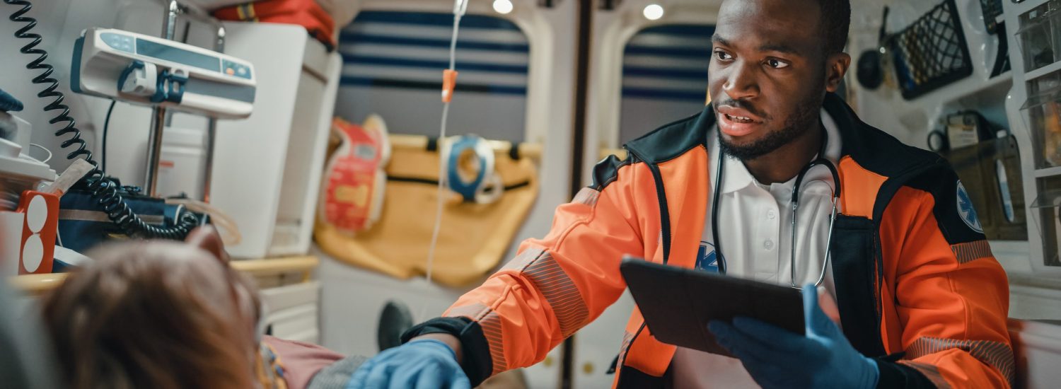 Emergency Medical Technician uses a tablet to help a patient