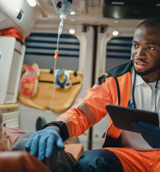 Emergency Medical Technician uses a tablet to help a patient