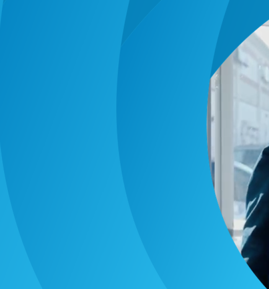Blue aperture patter curves around a photo of Rick in AT&T attire entering a retail store