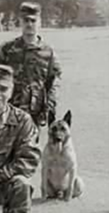 Man in military fatigues with dog