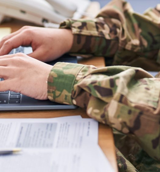 Military member works on a laptop
